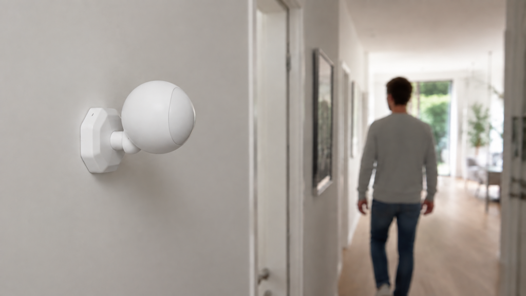 Tuya TS0202 motion sensor mounted high on a hallway wall and angled toward a person walking through the detection area.